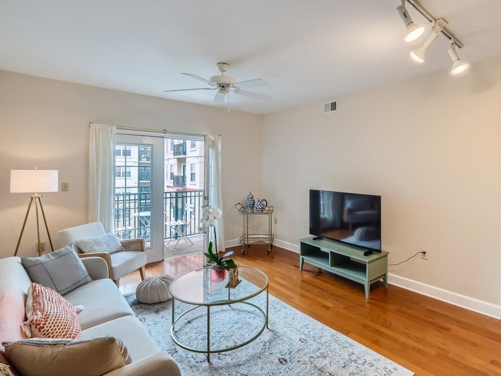 a living room with furniture a rug and a flat screen tv