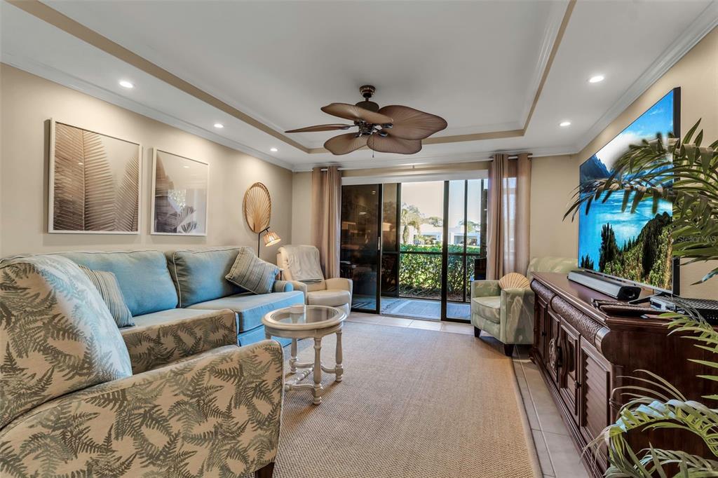 a living room with furniture fireplace and a large window