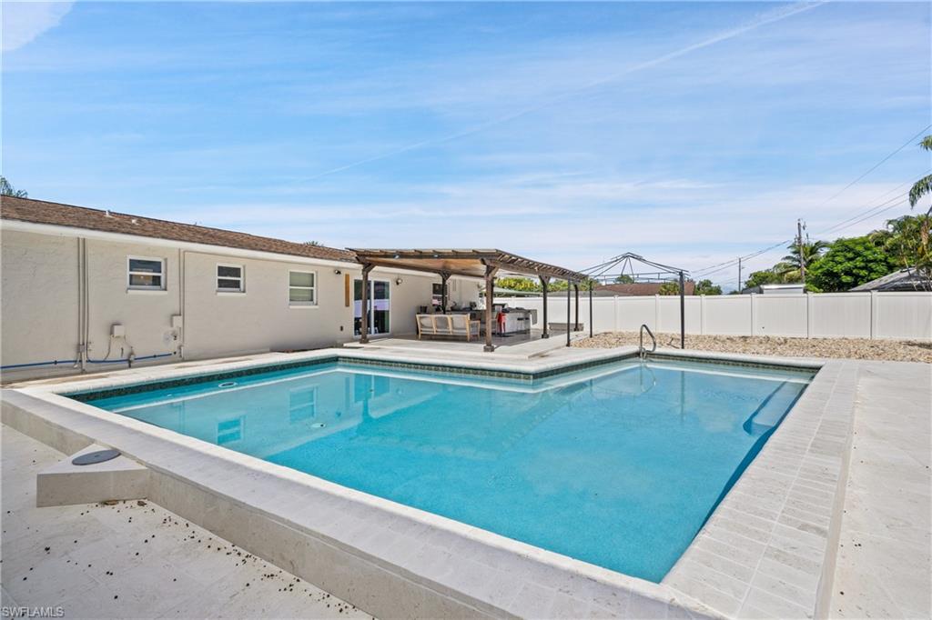 a view of swimming pool with outdoor seating