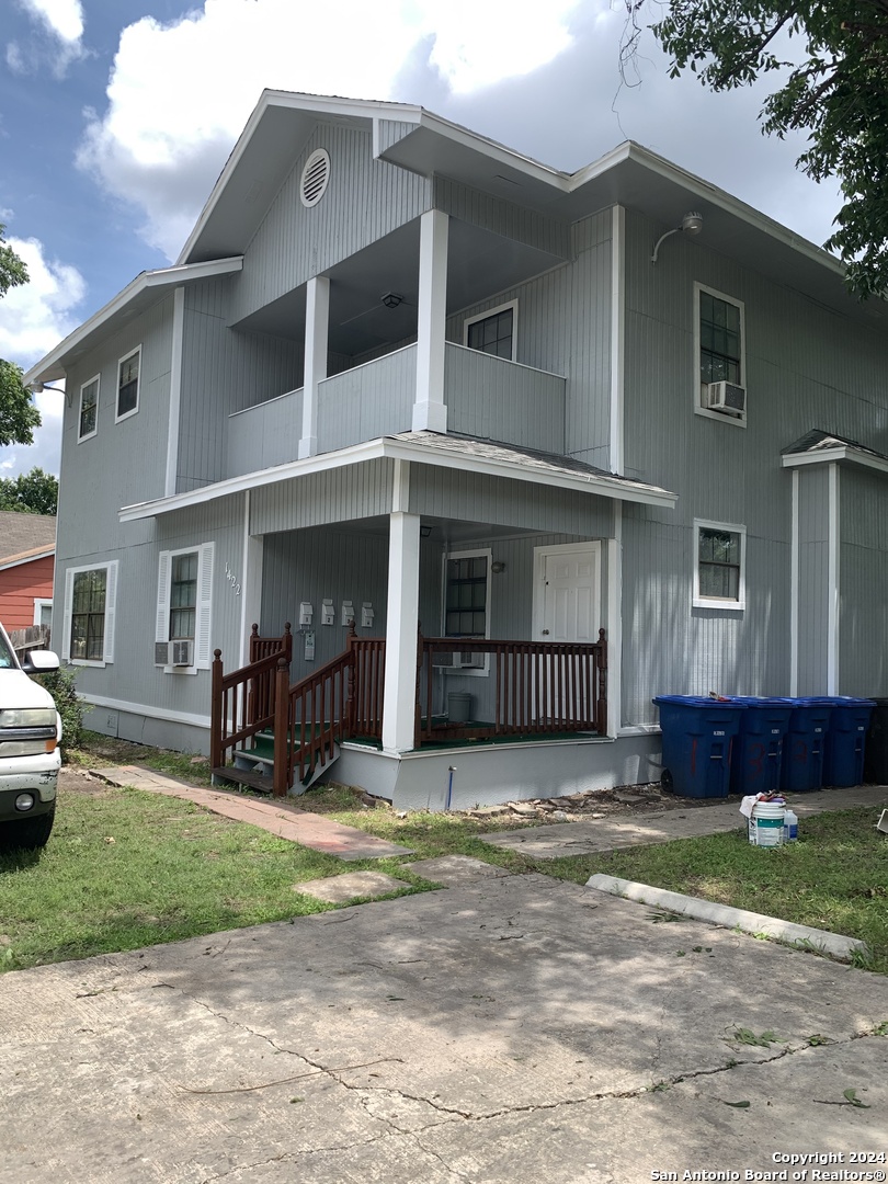 a front view of a house with a yard and seating space