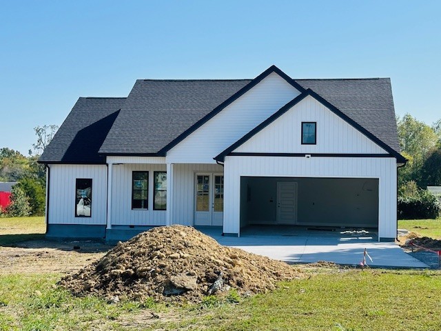 a view of a house with a yard and garage