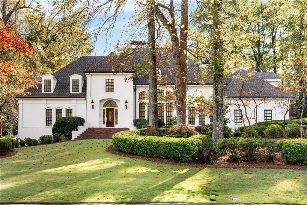 a front view of a house with a yard garage and outdoor seating