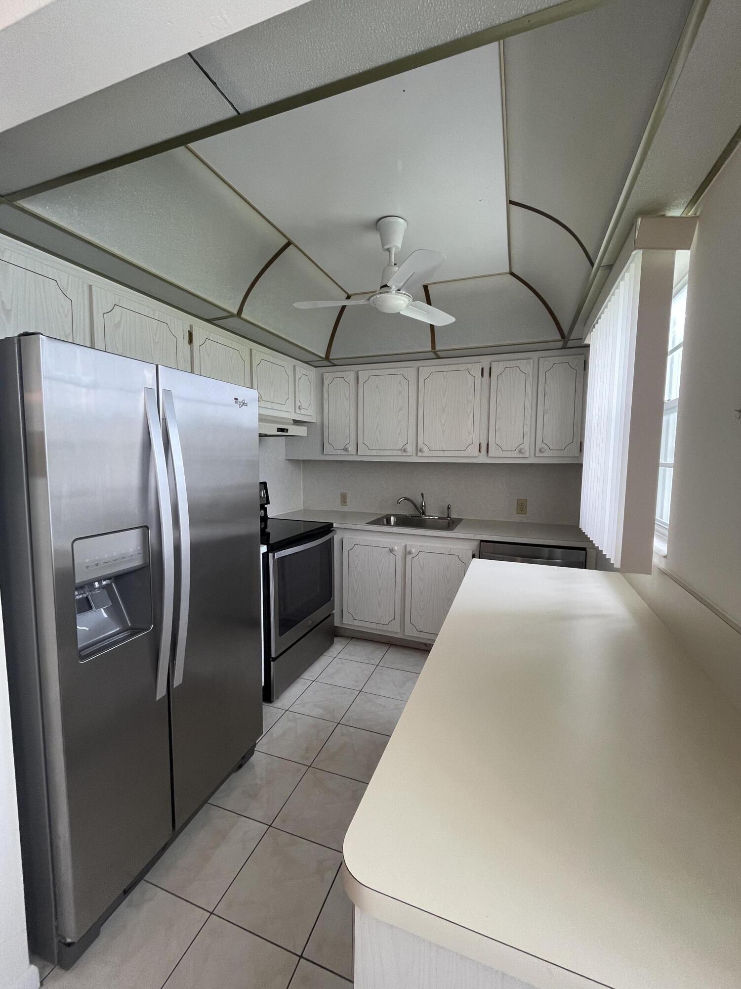 a kitchen with stainless steel appliances a refrigerator and a stove