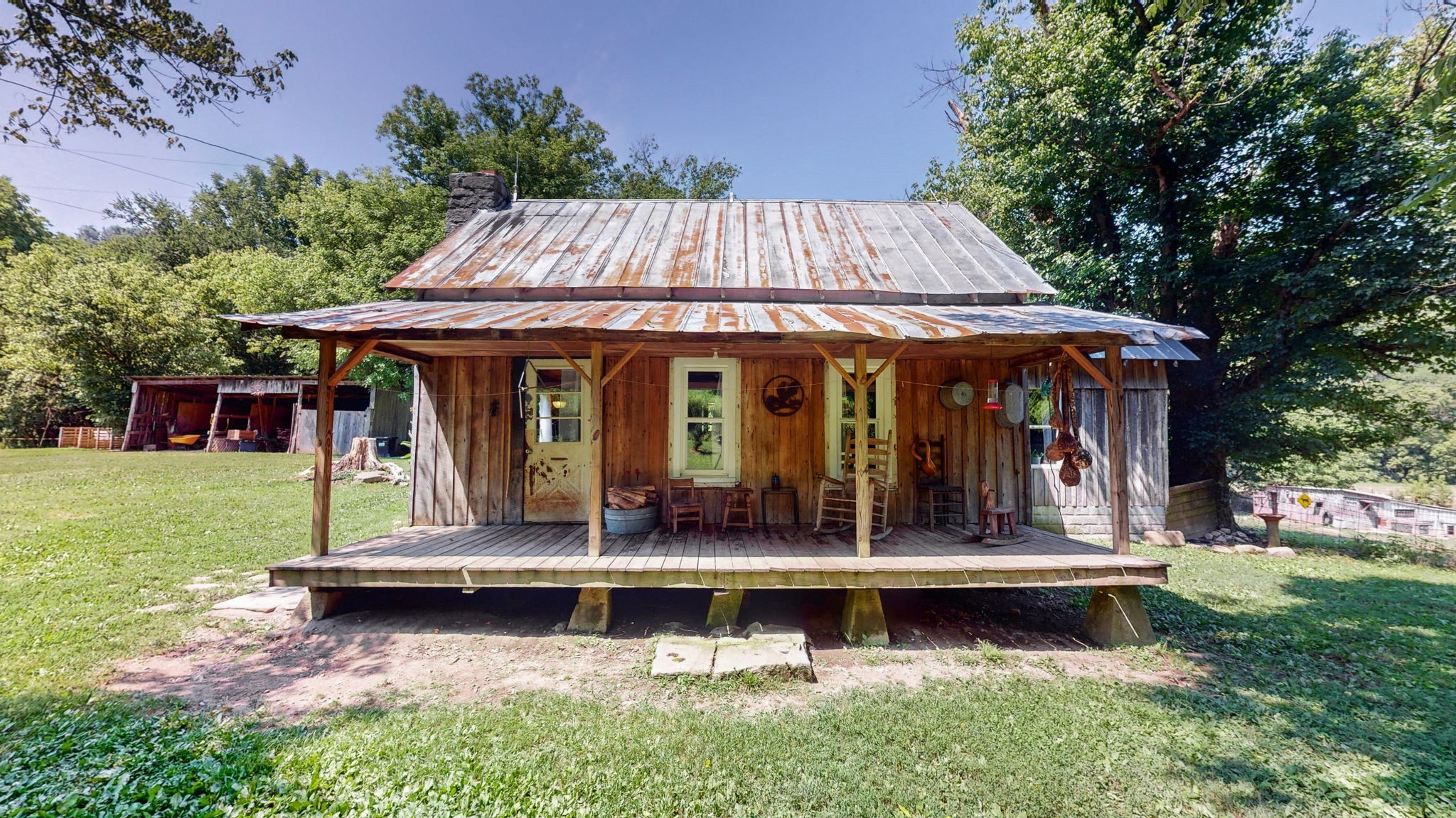 a view of a house with a yard balcony and wooden fence