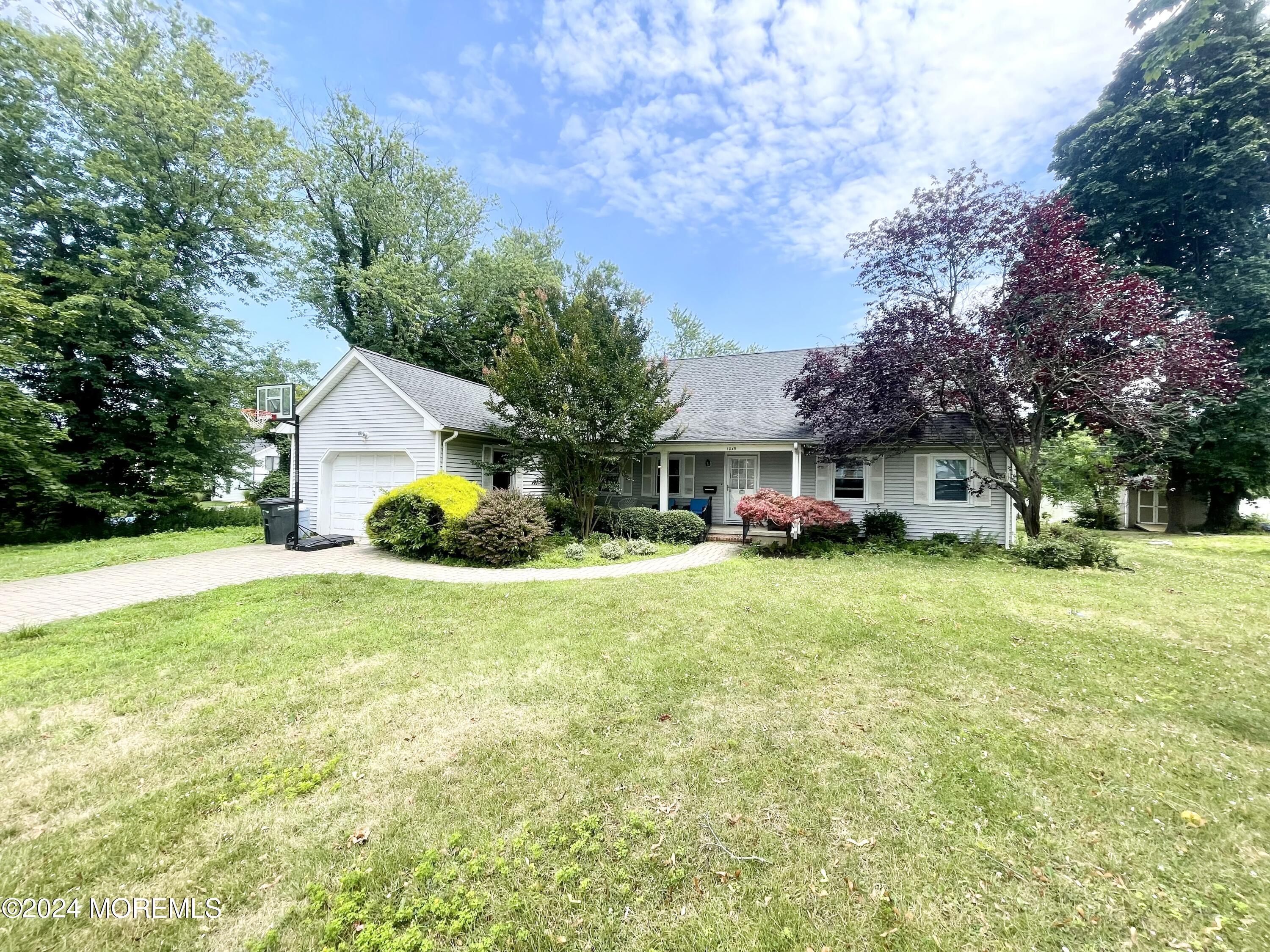 a front view of house with yard and trees