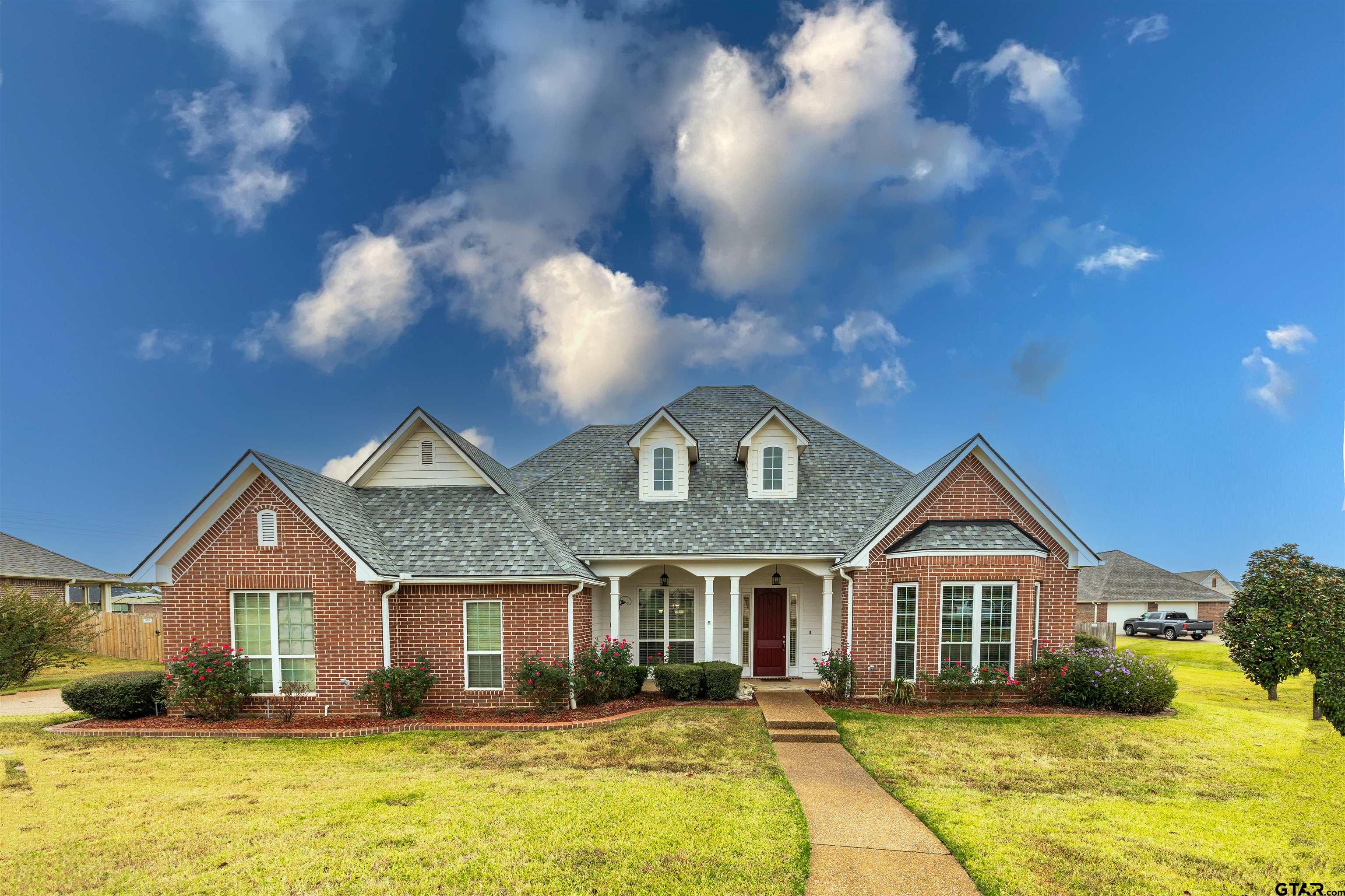 a front view of a house with a yard