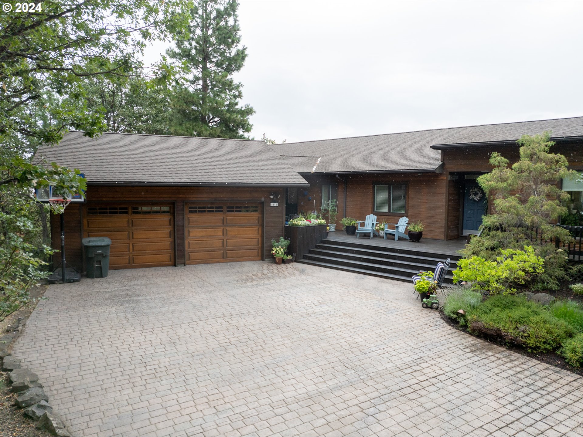 a front view of a house with a yard and a garage