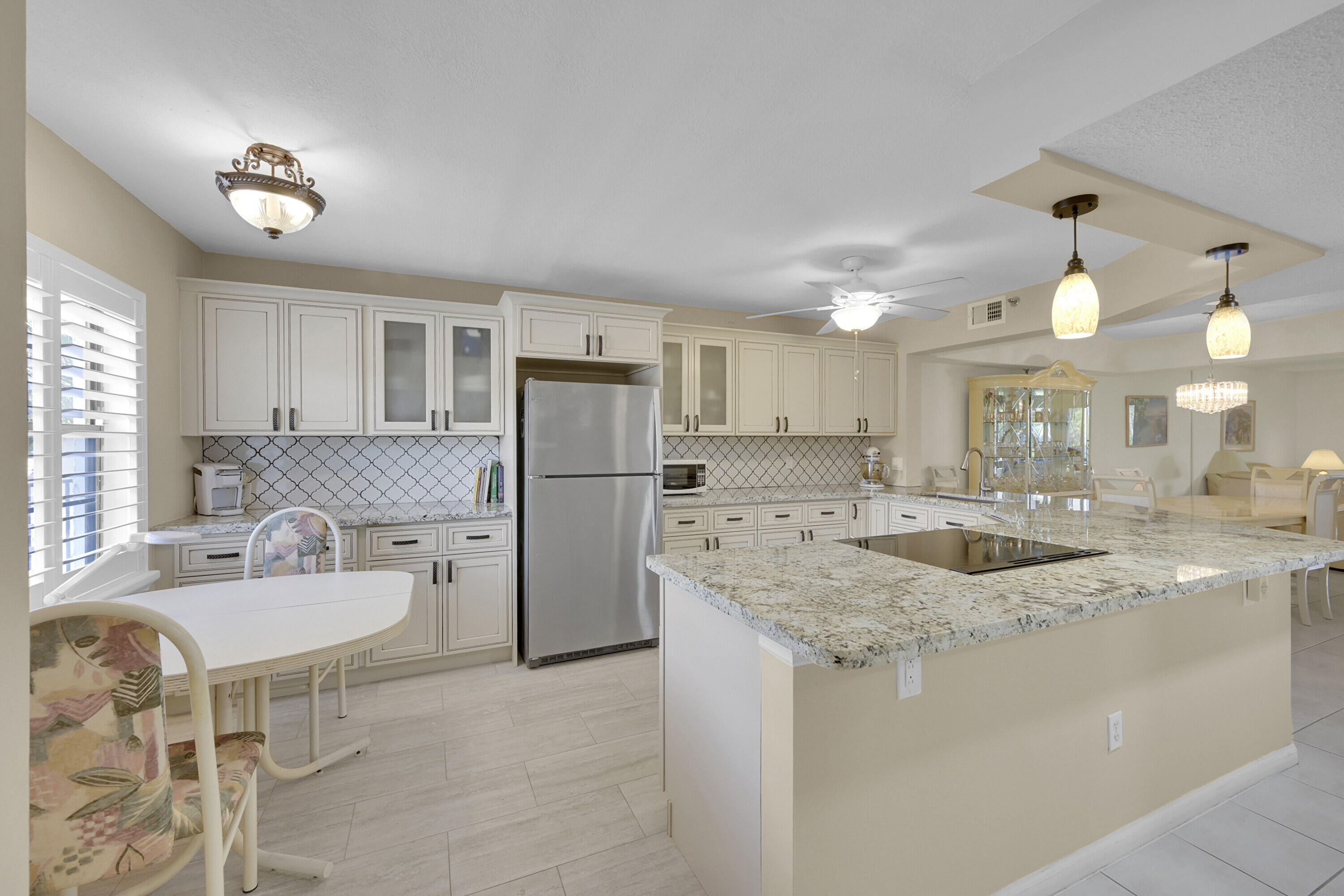 a kitchen with kitchen island a sink stove and refrigerator