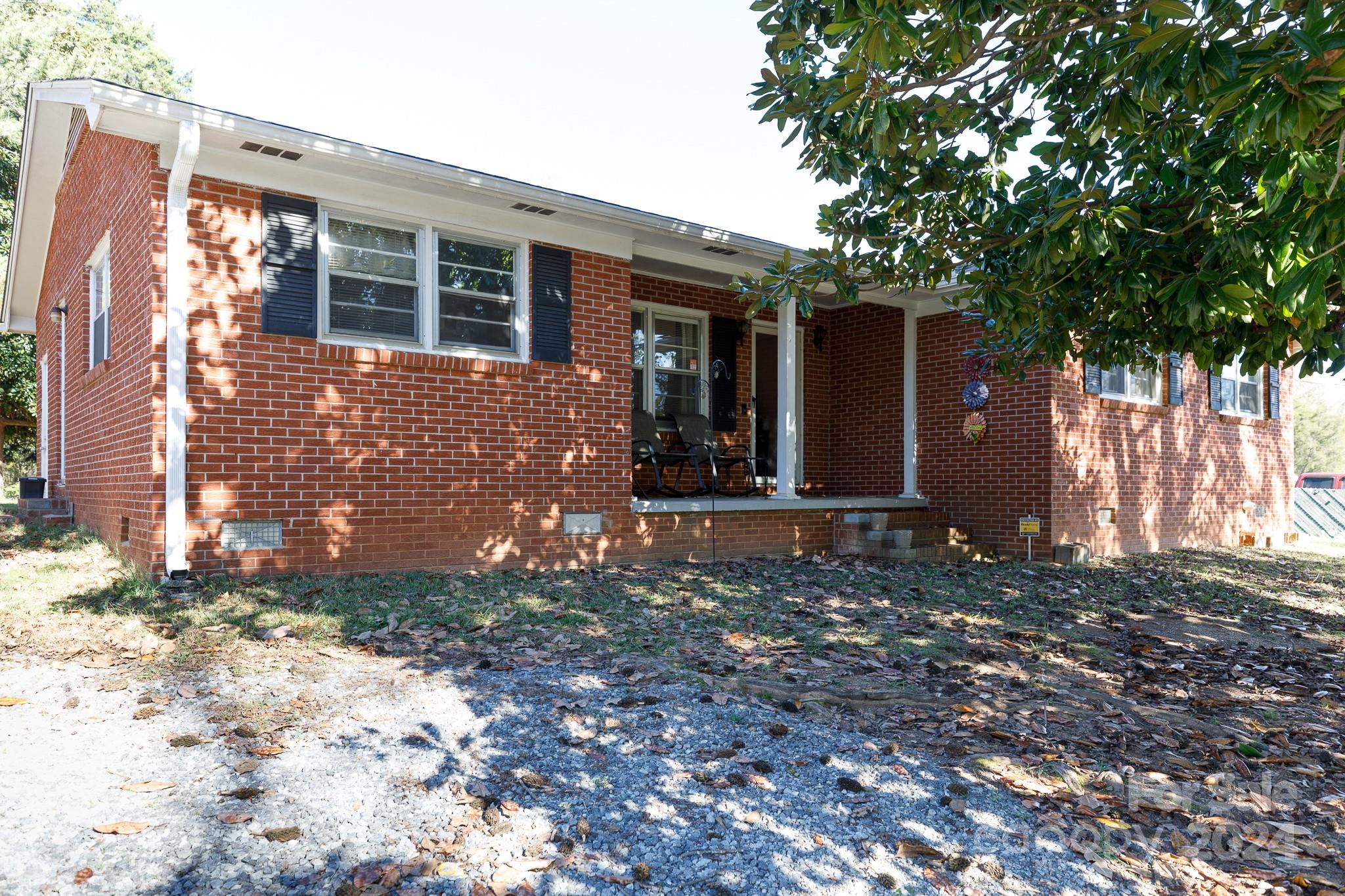 a view of a house with a tree