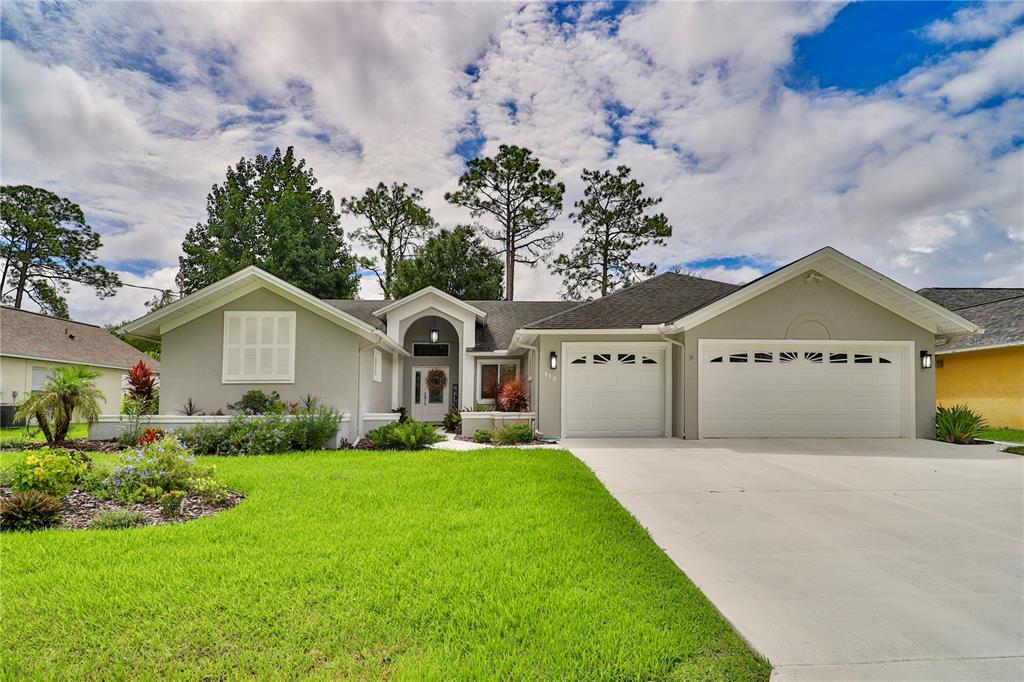 a front view of a house with a yard and garage