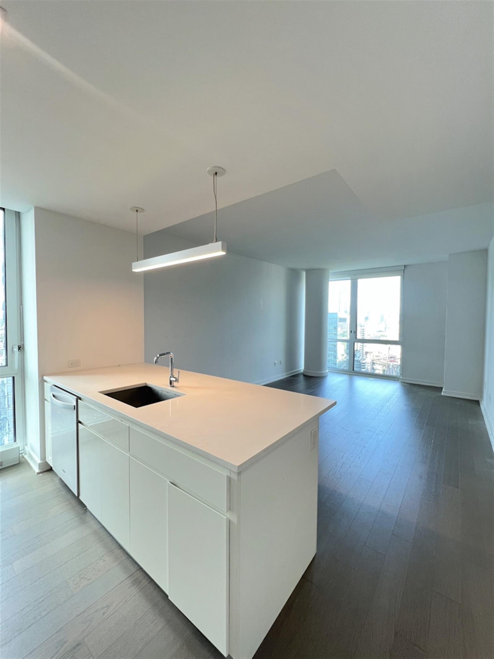 a kitchen with a stove and wooden floor