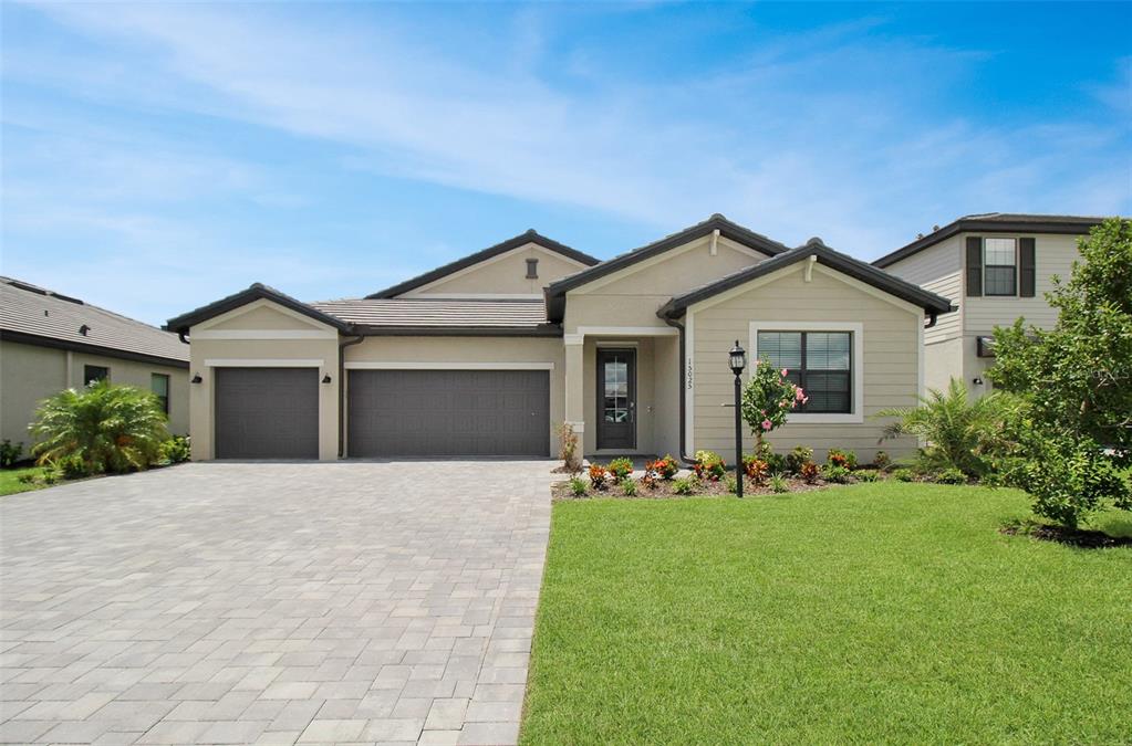 a front view of a house with a yard and garage