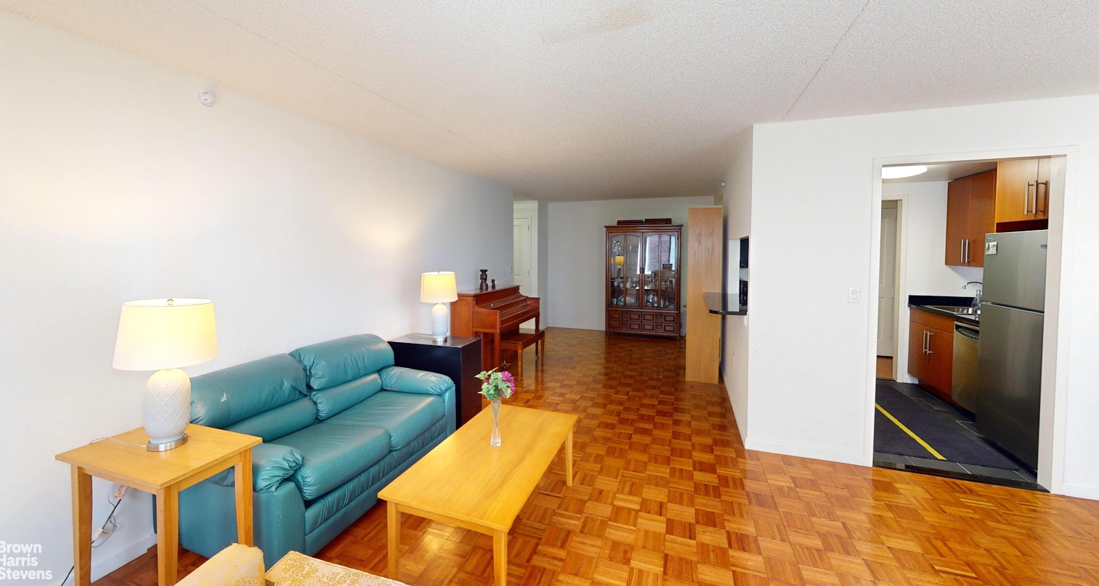 a living room with furniture and a kitchen