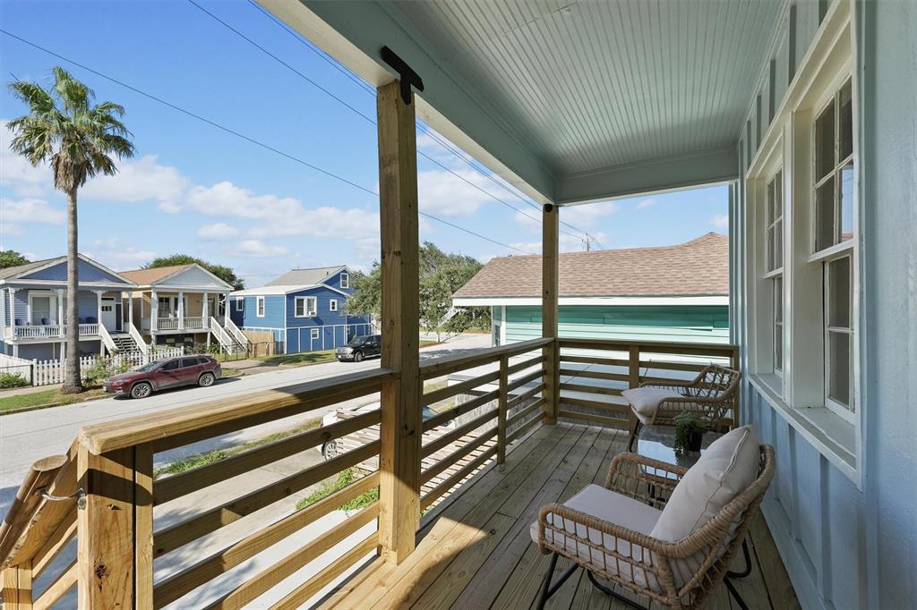 a view of a porch with furniture and garden