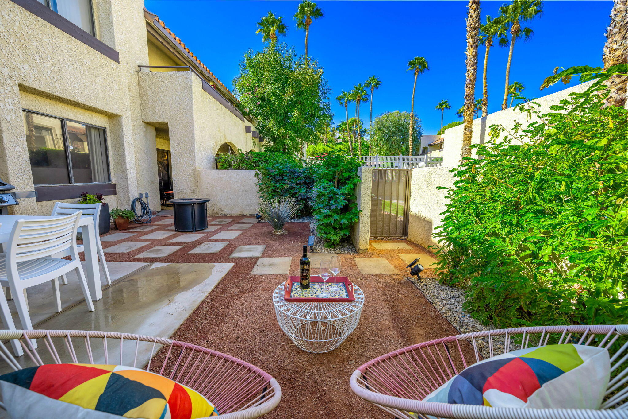 a backyard of a house with lots of green space and outdoor seating