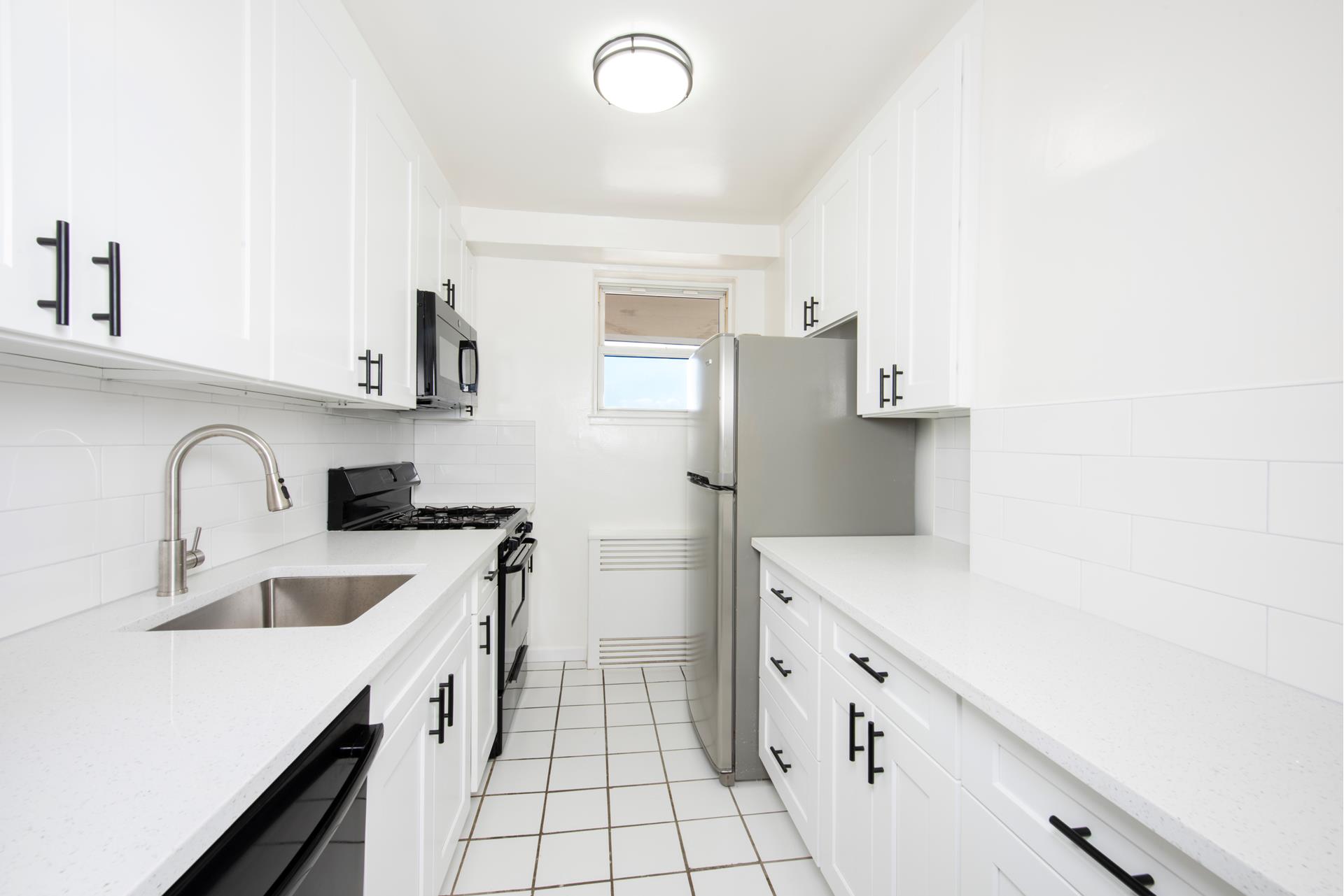 a kitchen with a sink dishwasher a refrigerator and a stove