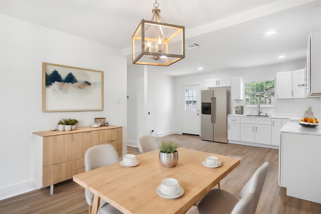 a kitchen with a table chairs and dining table