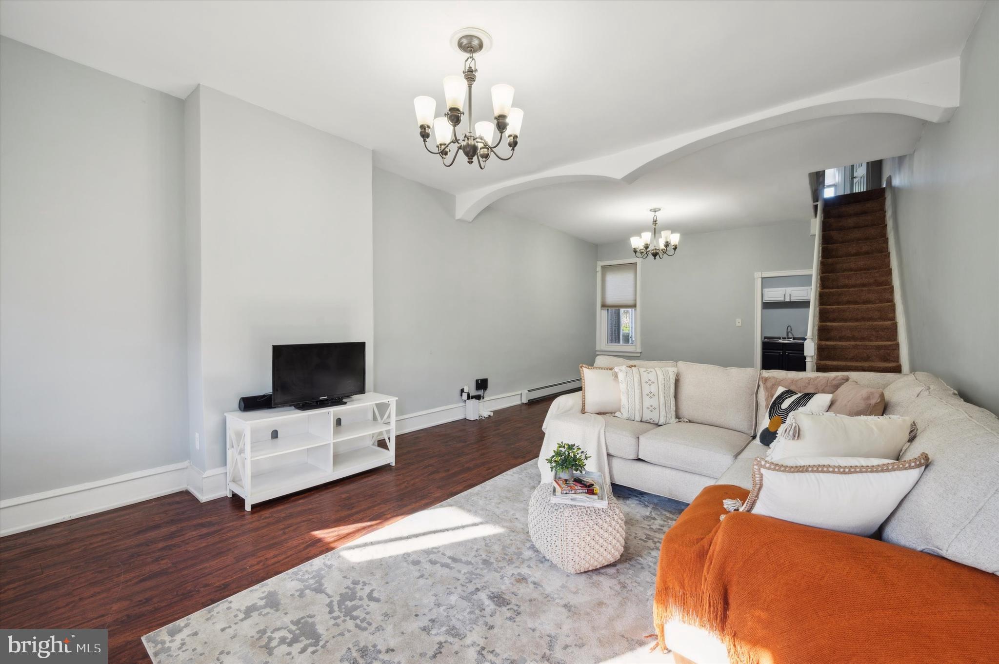 a living room with furniture and a flat screen tv