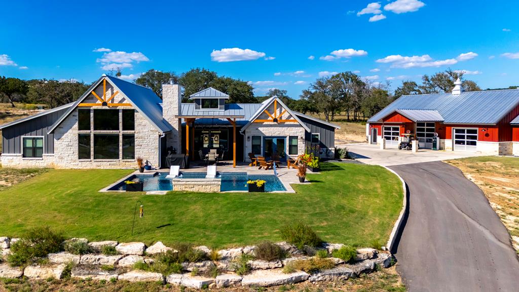 a front view of a house with swimming pool having outdoor seating