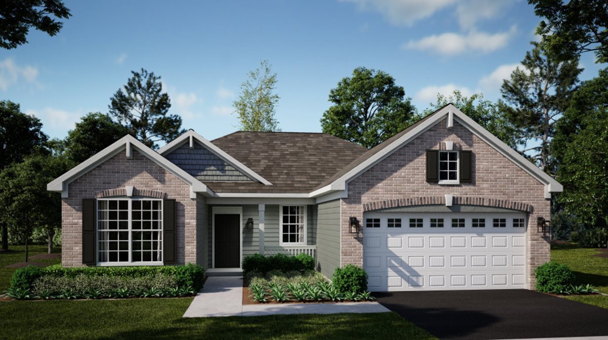 a front view of a house with a yard and trees