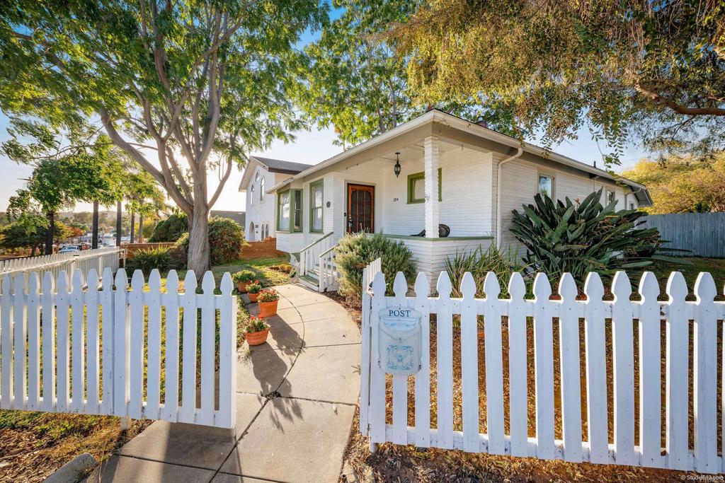 a view of a house with wooden fence