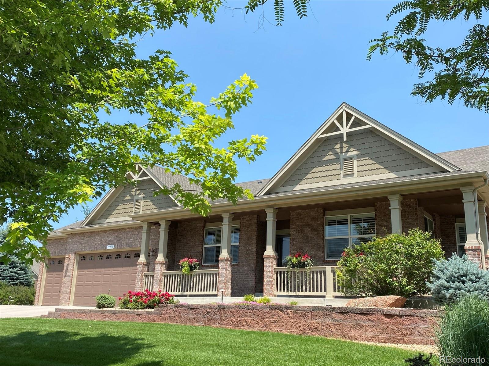 a front view of a house with a yard and porch