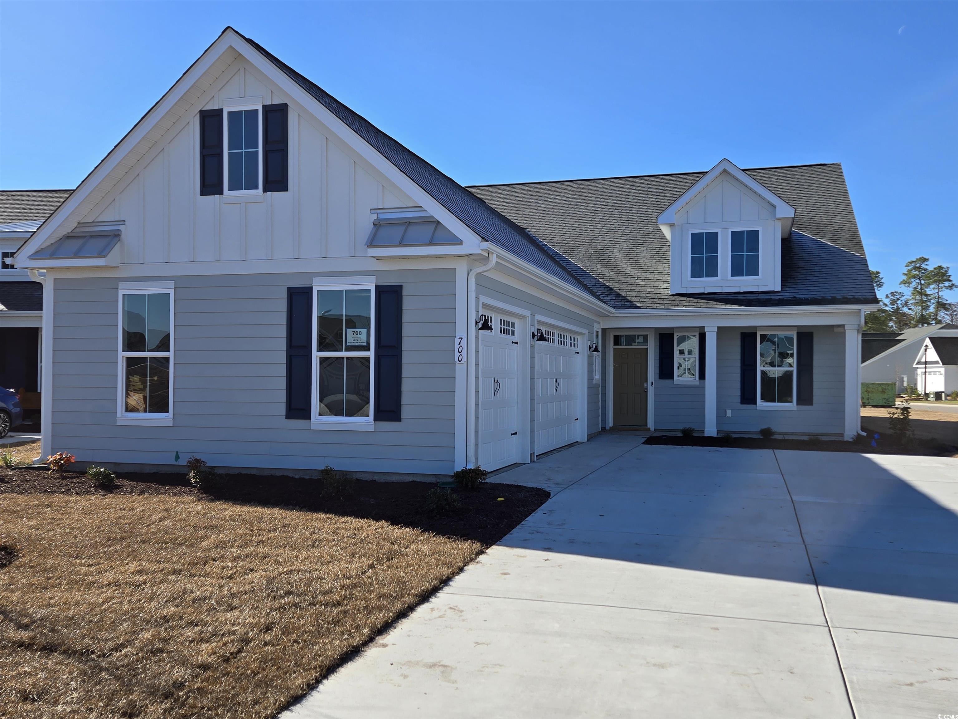 View of front of home with a garage, concrete driv