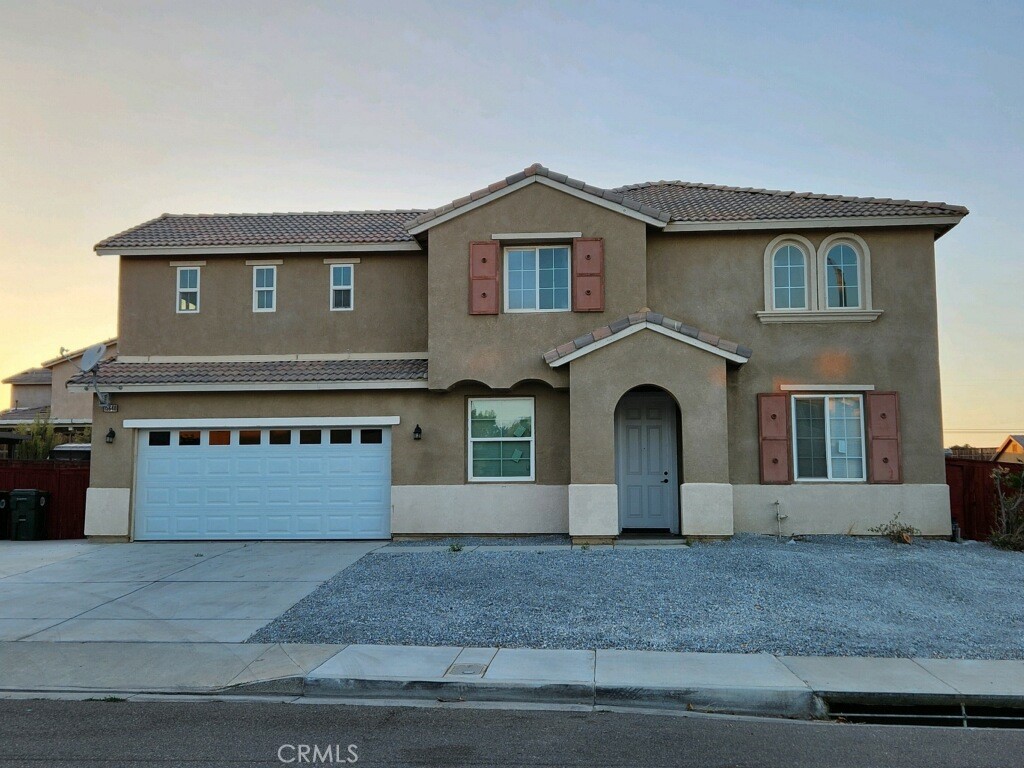 a view of a house with a yard and garage