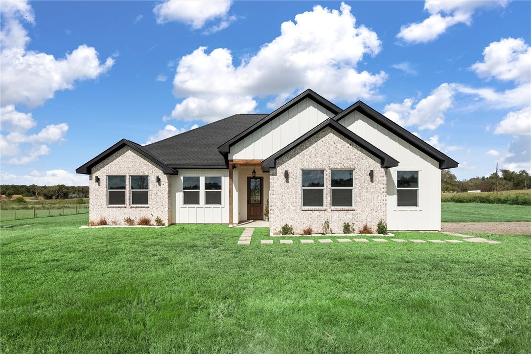 a front view of house with yard and green space