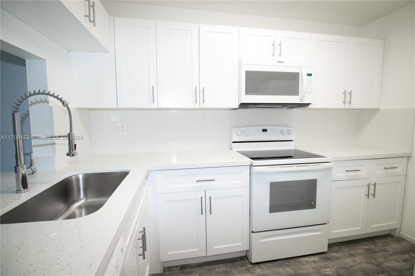 a kitchen with cabinets and white appliances