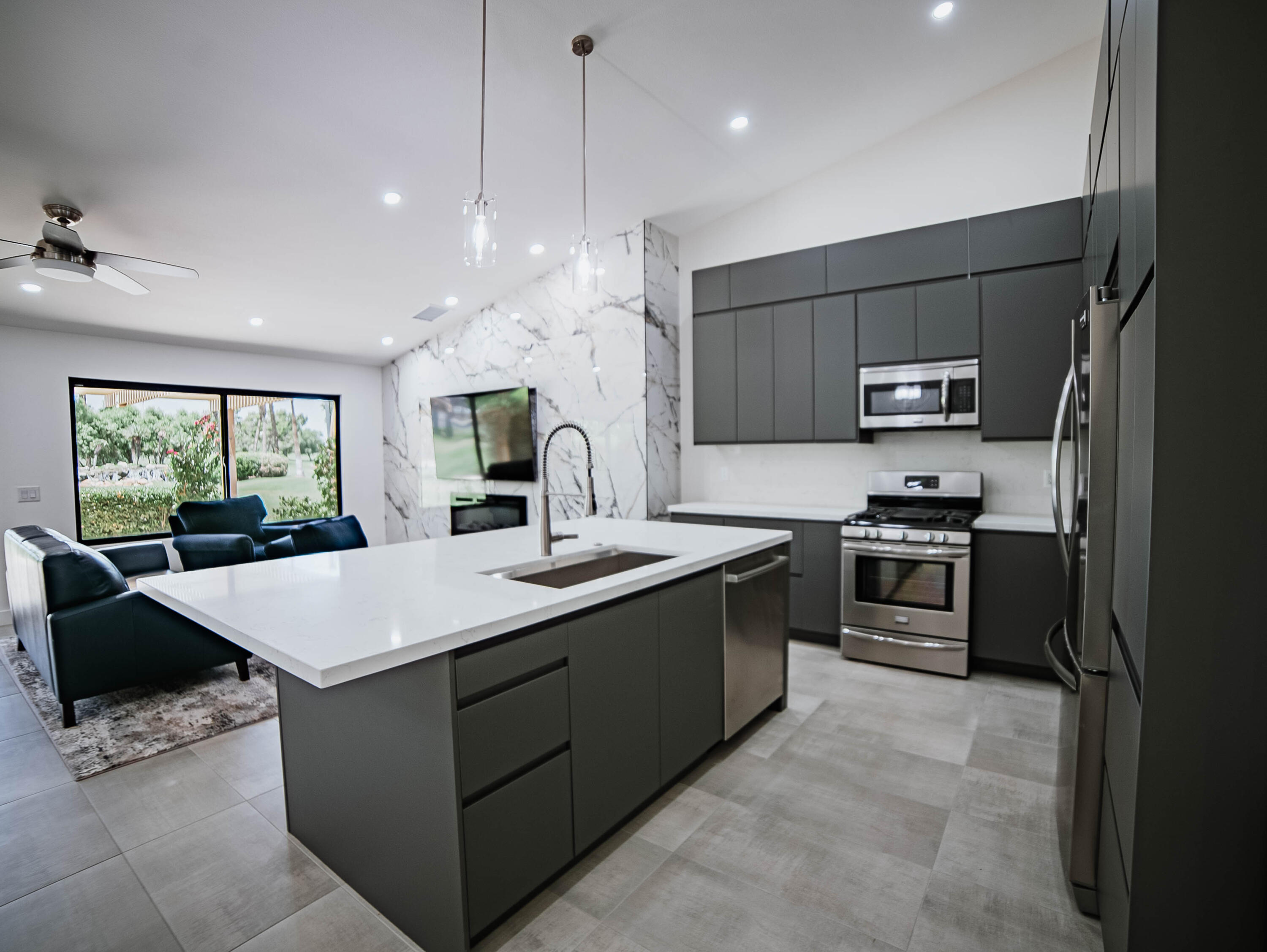 a kitchen with kitchen island a sink stove and refrigerator