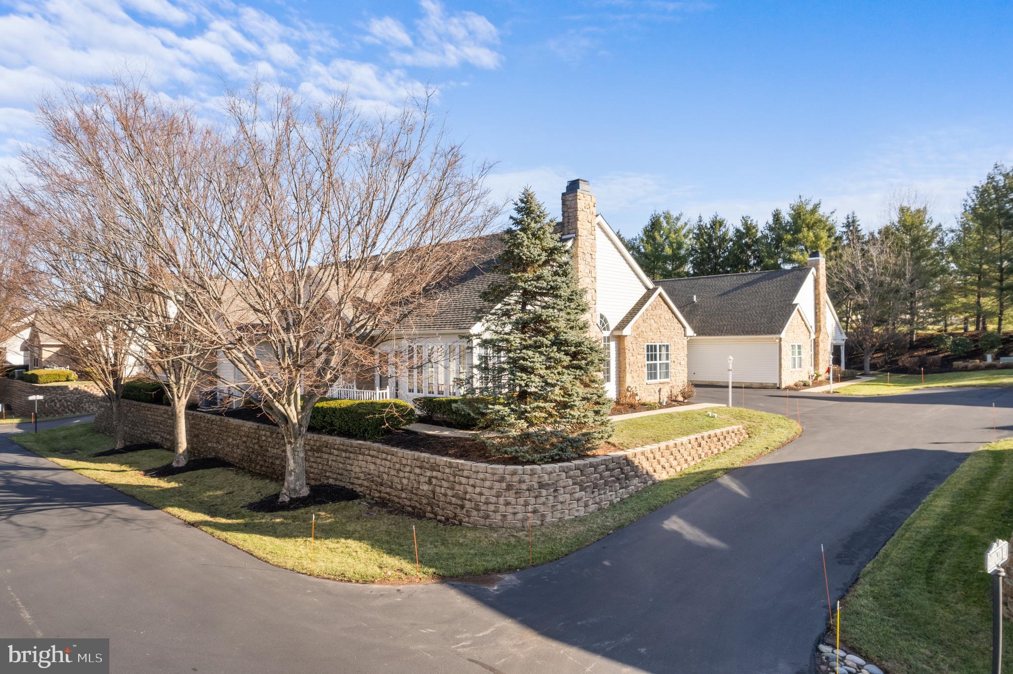 a view of a house with backyard and a tree