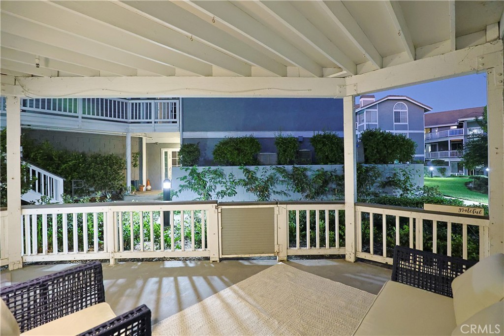 a view of a house with a wooden deck