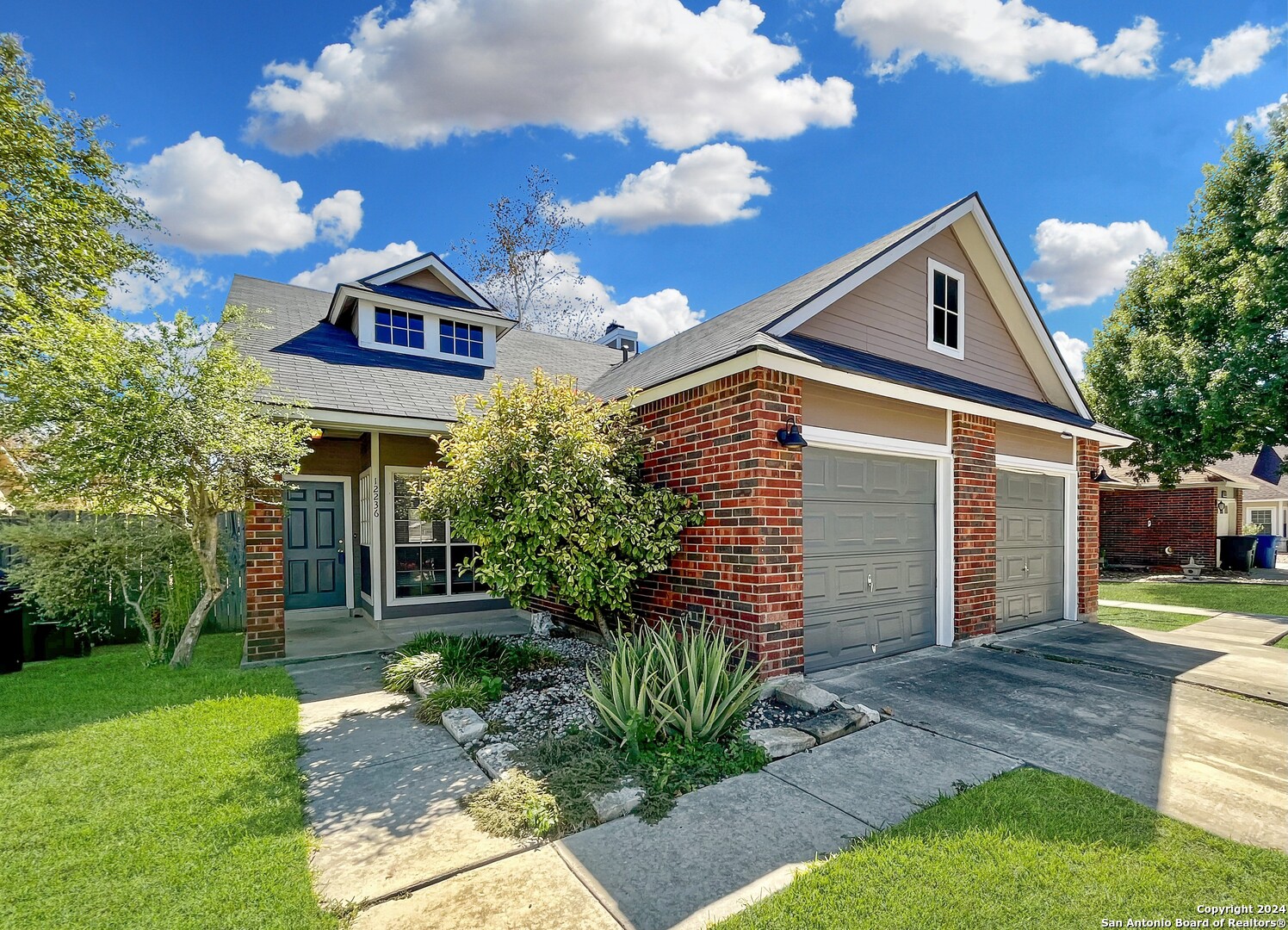 a front view of a house with garden