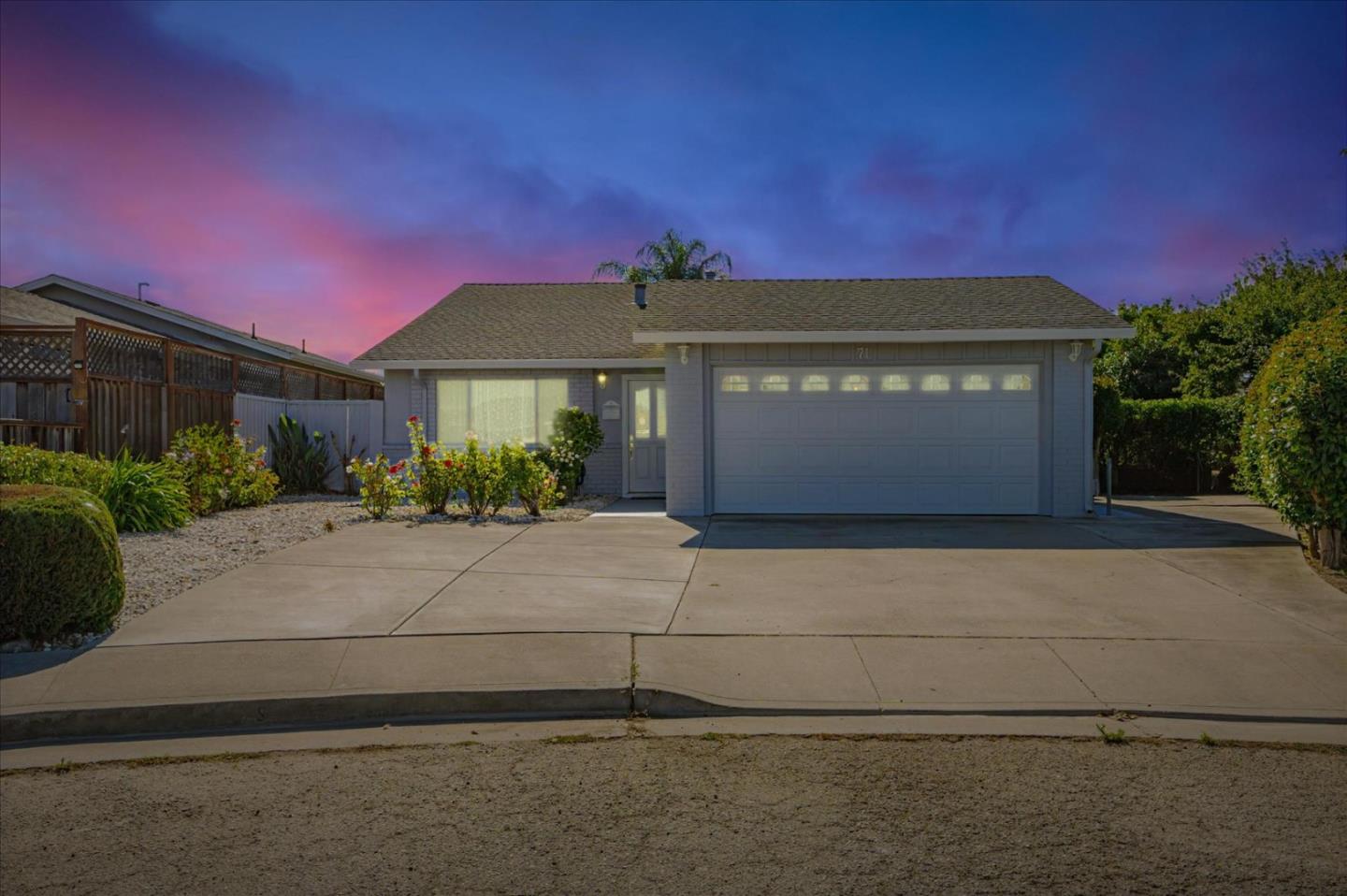 a front view of a house with a yard and a garage