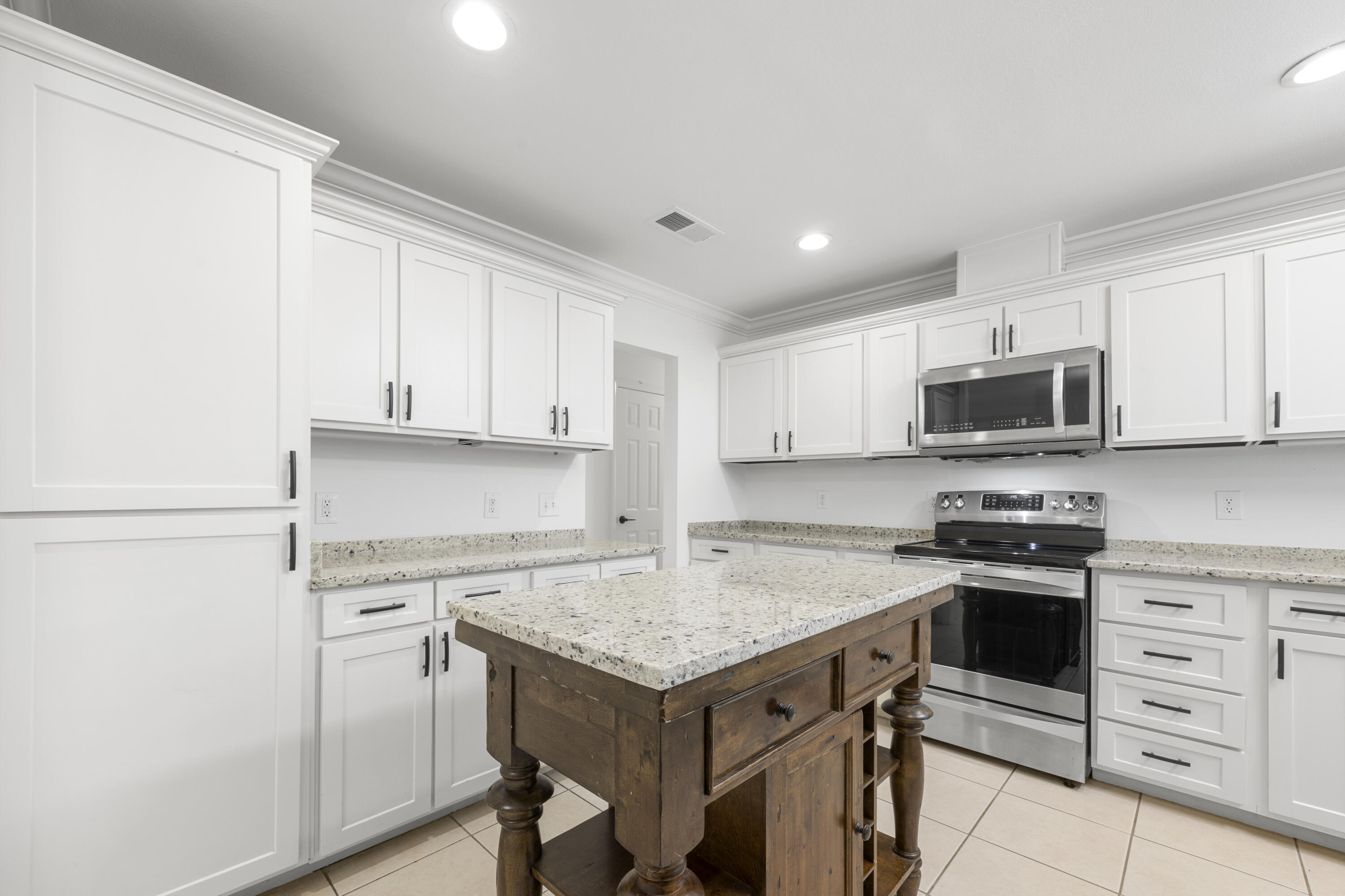 a kitchen with a stove a sink and a refrigerator