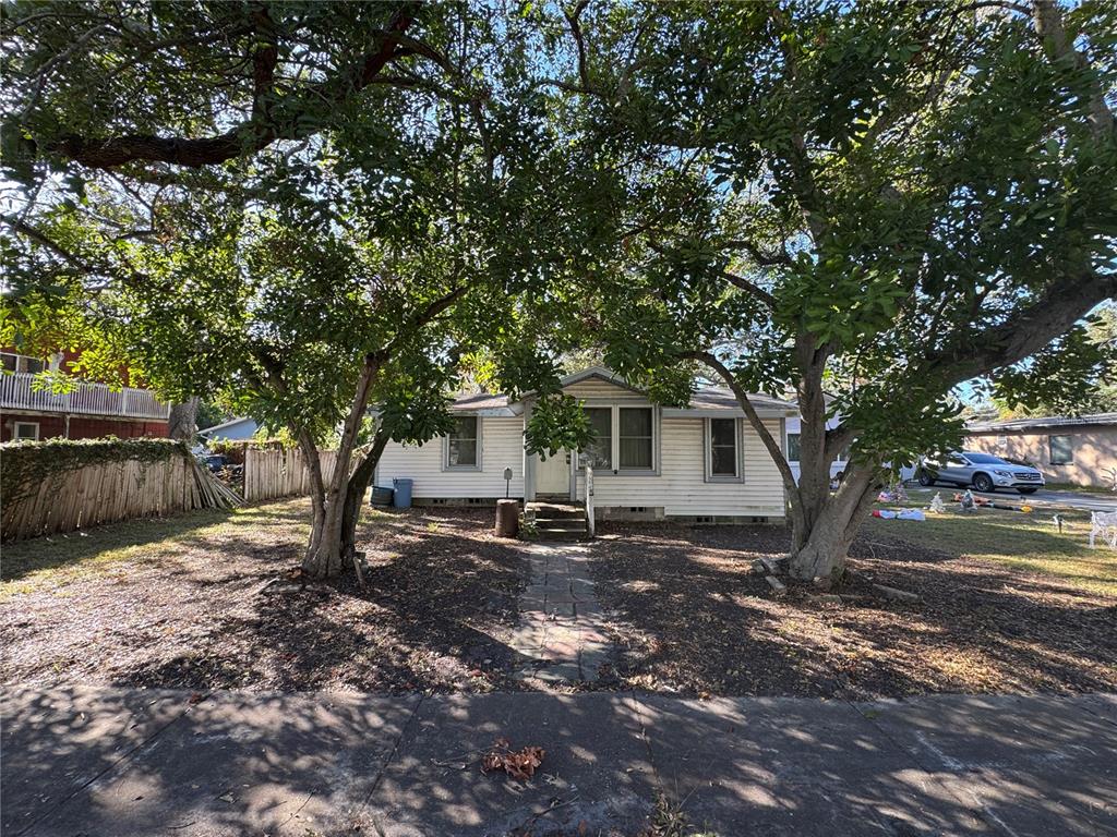 a view of a house with a tree in the background