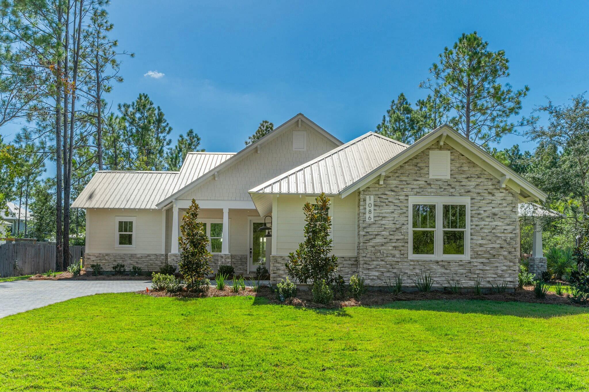 a front view of a house with a yard and porch