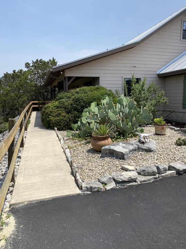 a view of house with yard and sitting area