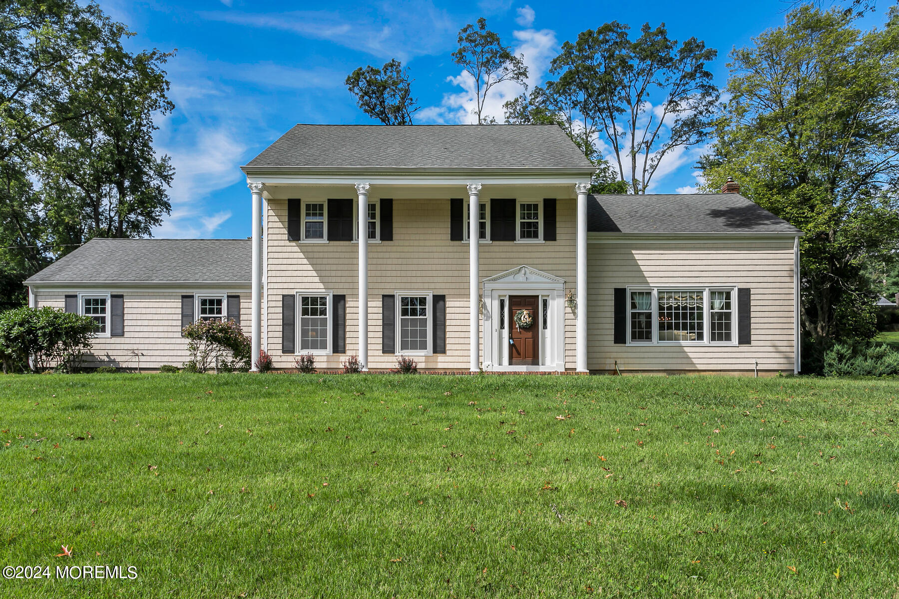 a front view of a house with a garden