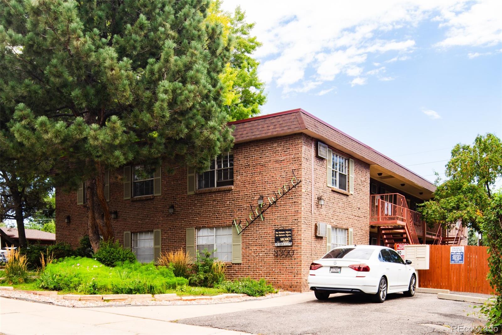 a car parked in front of a brick house