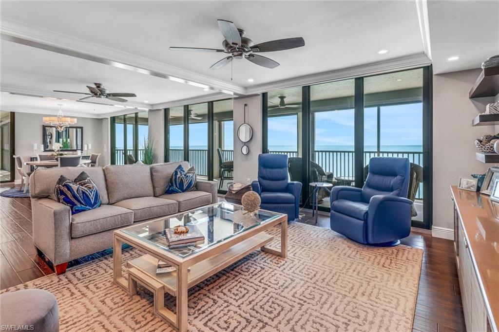 a living room with furniture a large window and a rug