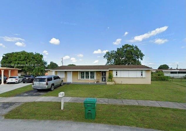 a front view of a house with a garden and yard