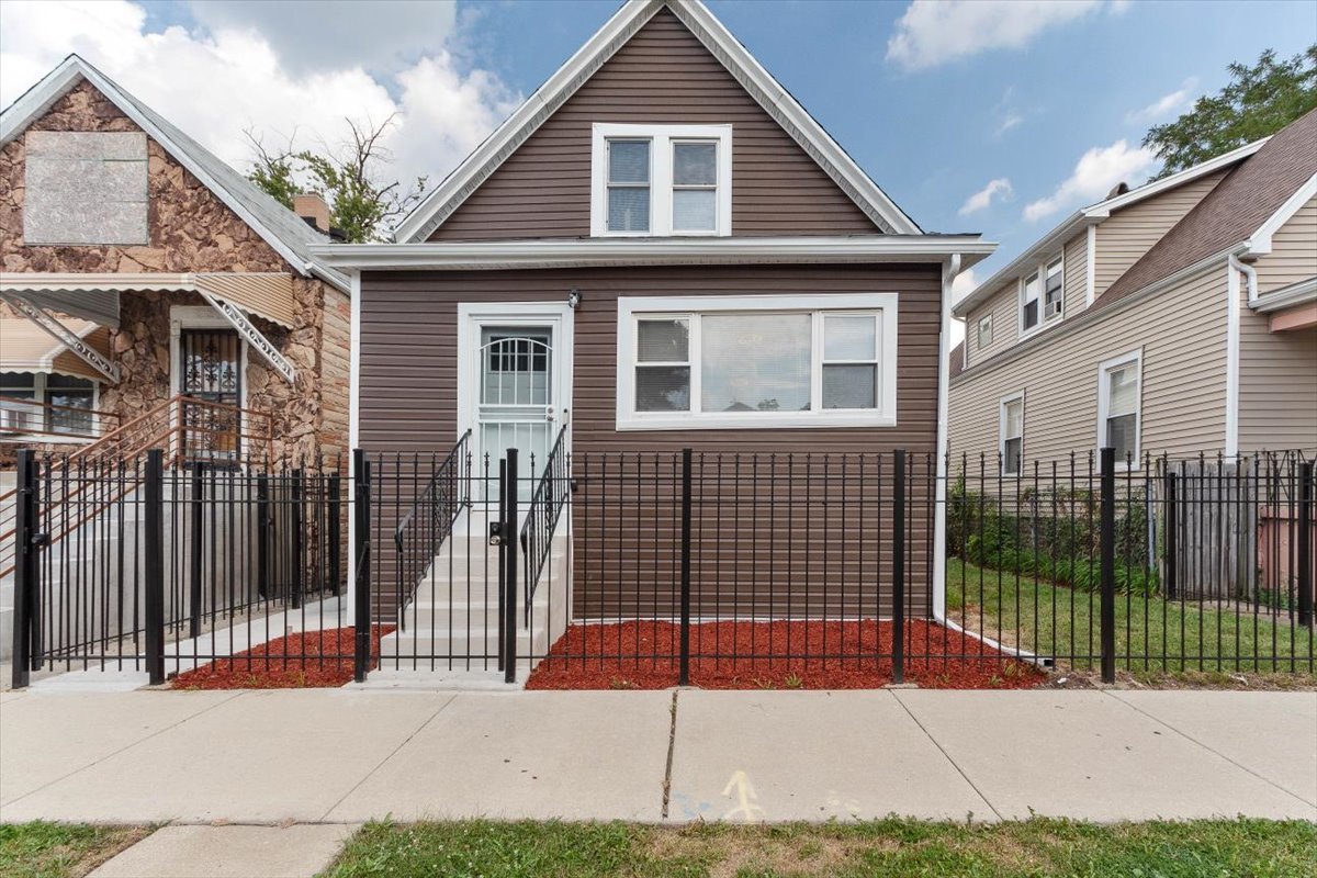 a view of a house with wooden fence