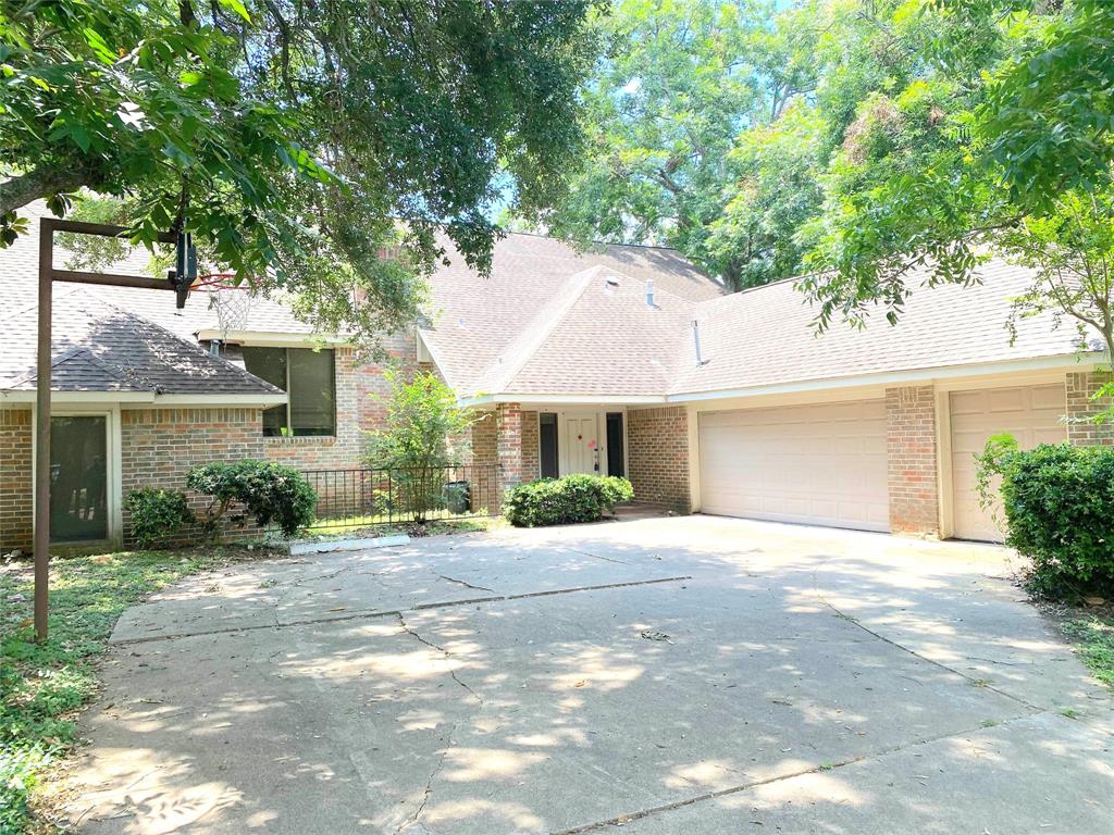 a front view of a house with a yard and a garage