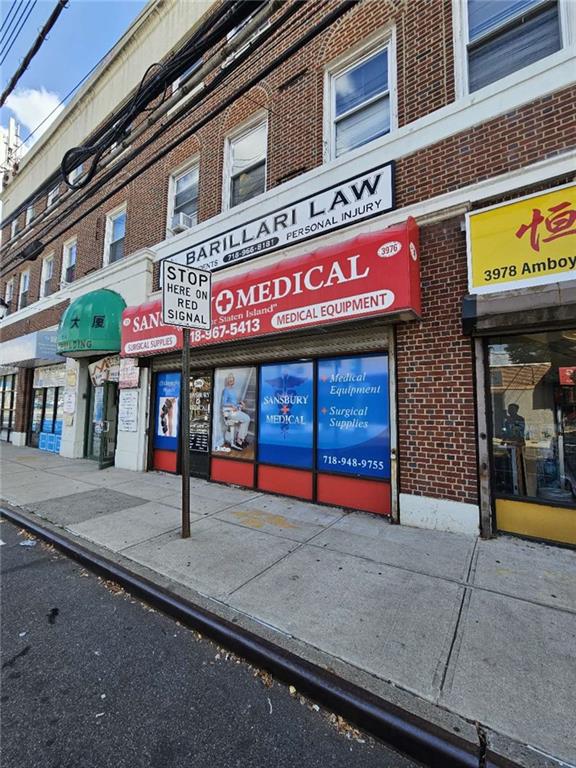 a front view of multi story building with retail shop