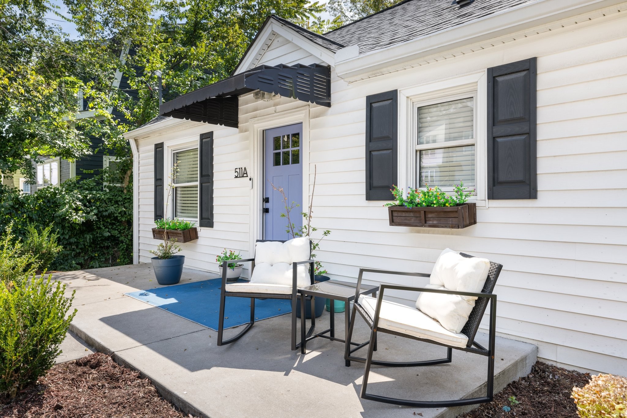 a view of a patio with table and chairs and potted plants