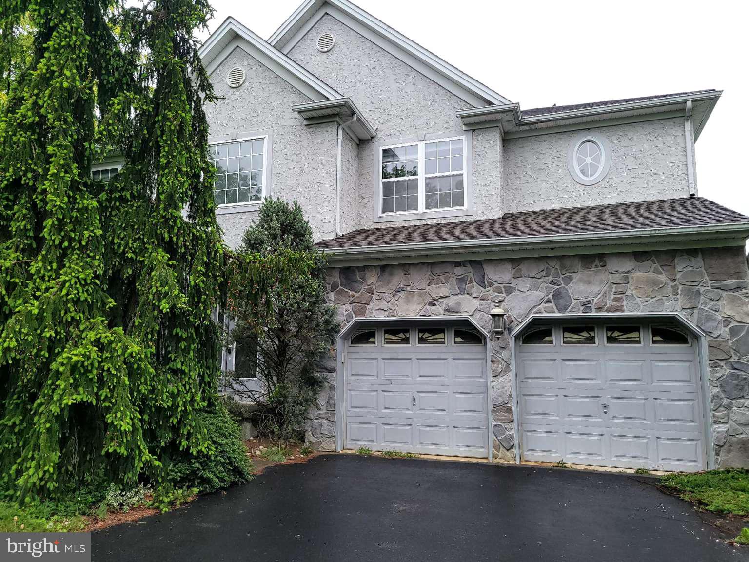 a view of a house with a yard and garage