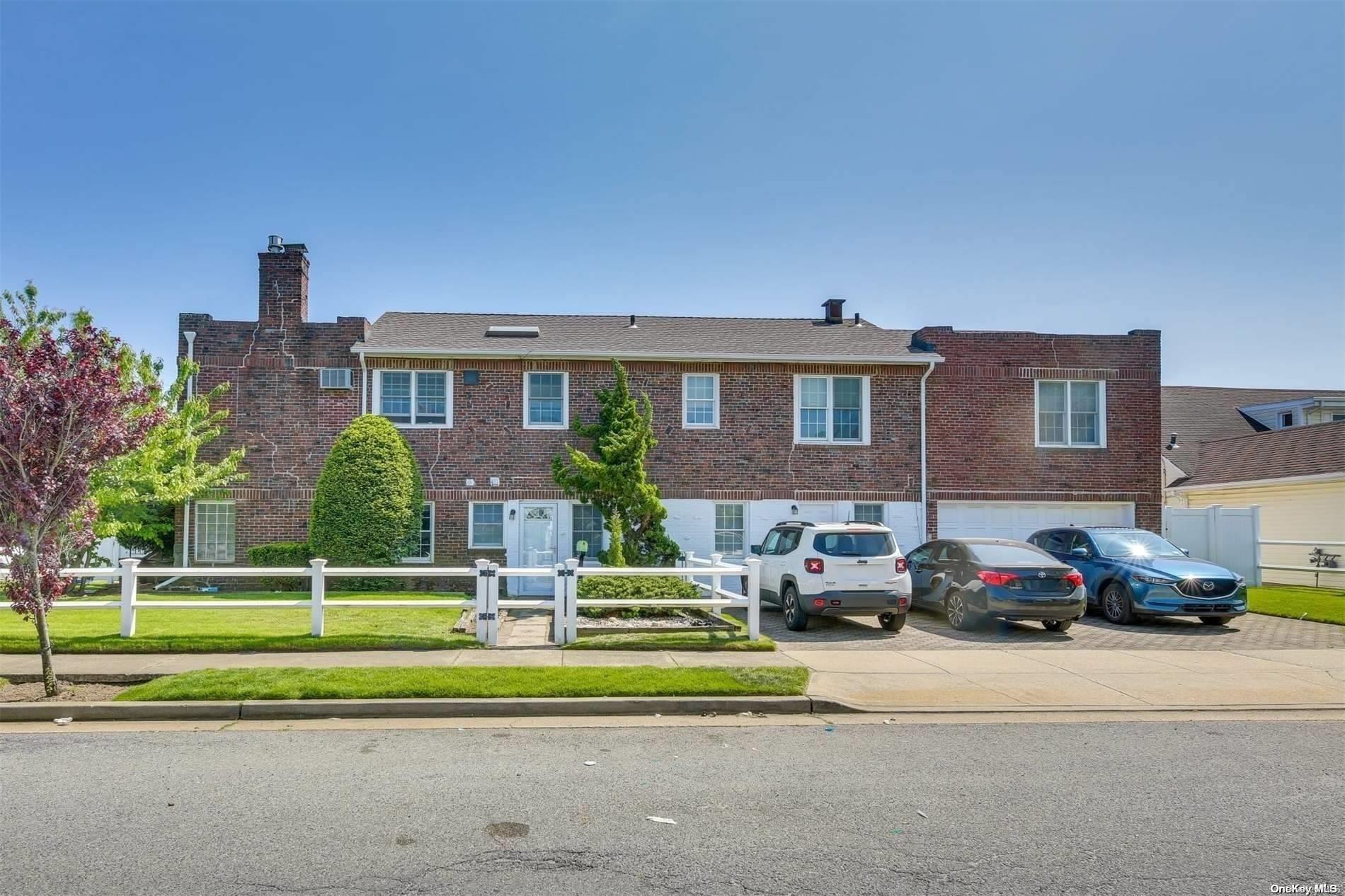 a front view of a residential apartment building with a yard