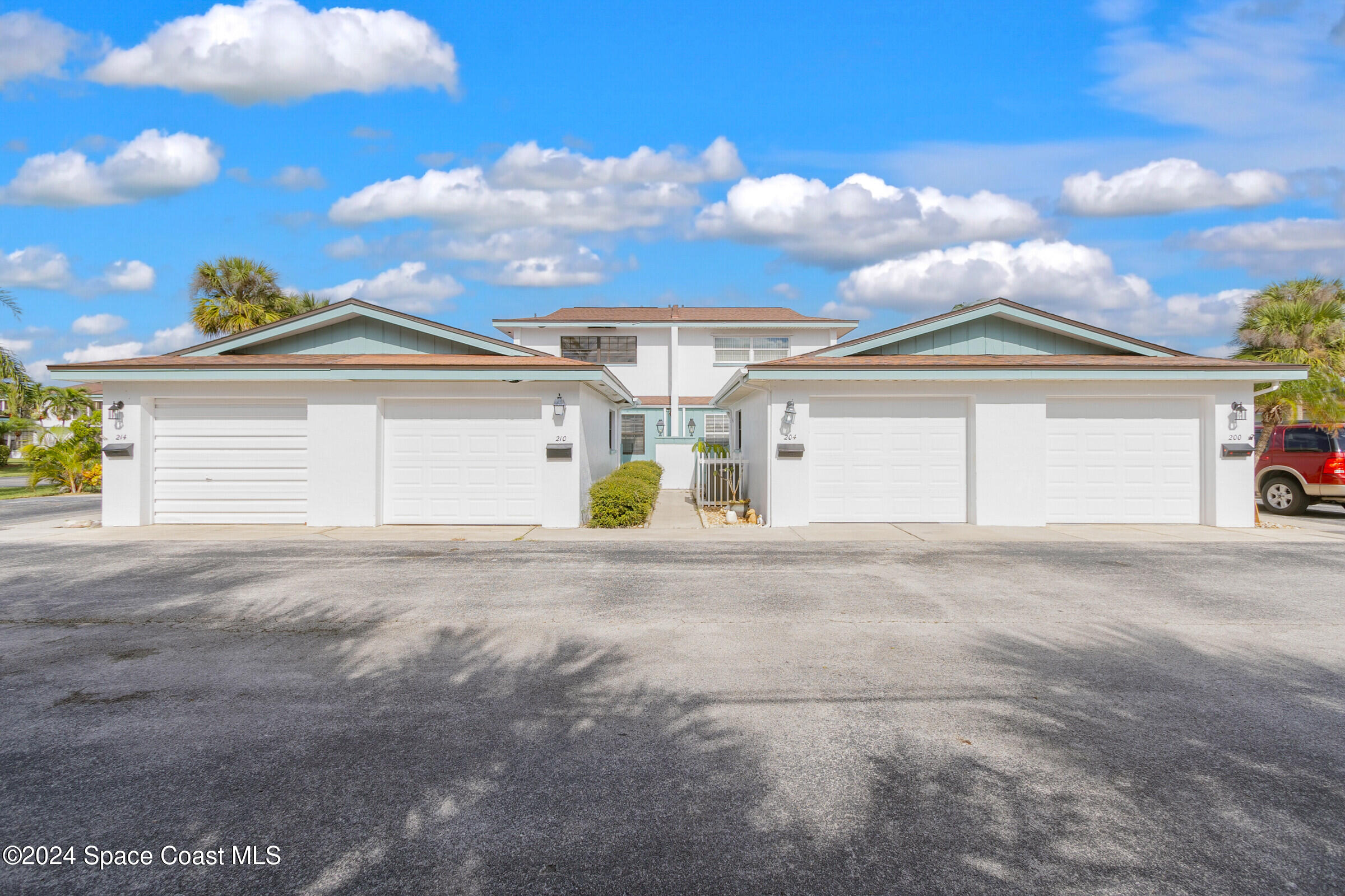 a view of a house with a yard and garage